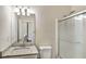 Clean bathroom with granite vanity top, shower with glass door, and tile flooring, providing a modern feel at 6793 Oconee Pl, Fairburn, GA 30213