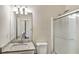 Bathroom features a granite vanity, shower, and updated lighting at 6793 Oconee Pl, Fairburn, GA 30213