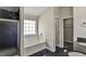 Bathroom features a separate shower, garden tub, and black tile floors at 6793 Oconee Pl, Fairburn, GA 30213