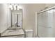 Bathroom with granite countertop vanity, large mirror, and glass shower with a shower head at 6793 Oconee Pl, Fairburn, GA 30213