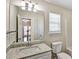 Bathroom view featuring granite counters, a vanity, and a large mirror at 6793 Oconee Pl, Fairburn, GA 30213
