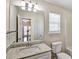 Bathroom with granite counters, tile floors, and large mirror at 6793 Oconee Pl, Fairburn, GA 30213