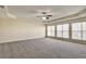 Large bedroom features tray ceilings, a ceiling fan, and bright natural light at 6793 Oconee Pl, Fairburn, GA 30213
