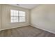 Bedroom featuring neutral carpeting, a window with blinds, and ample natural light at 6793 Oconee Pl, Fairburn, GA 30213