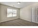 Bedroom featuring neutral carpet, closet, and window letting in natural light at 6793 Oconee Pl, Fairburn, GA 30213