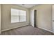 Cozy bedroom featuring plush carpet, natural light from a window, and closet for ample storage at 6793 Oconee Pl, Fairburn, GA 30213