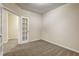 Cozy room with carpet, white walls, and an opening to another room for a spacious atmosphere at 6793 Oconee Pl, Fairburn, GA 30213