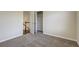 The bedroom showcases neutral carpeting and an open closet at 6793 Oconee Pl, Fairburn, GA 30213