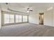 Spacious bedroom with a ceiling fan and lots of natural light from large windows at 6793 Oconee Pl, Fairburn, GA 30213