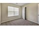 Cozy bedroom featuring neutral carpet, blinds, and an open closet for storage at 6793 Oconee Pl, Fairburn, GA 30213