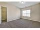 Well-lit bedroom featuring a big window, soft carpet, and an organized closet at 6793 Oconee Pl, Fairburn, GA 30213