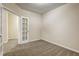 Carpeted bedroom featuring a French door leading to an additional space at 6793 Oconee Pl, Fairburn, GA 30213