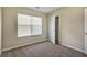Bedroom with plush carpeting, a window with blinds, and a closet and door at 6793 Oconee Pl, Fairburn, GA 30213