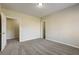 Neutral bedroom with carpet, white door, and adjacent walk-in closet provides a calm and soothing space at 6793 Oconee Pl, Fairburn, GA 30213