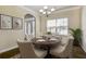 Dining room features elegant decor, hardwood floors, and ample seating around a wooden table at 6793 Oconee Pl, Fairburn, GA 30213