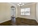The dining room offers hardwood floors, a chandelier, and a large window for natural lighting at 6793 Oconee Pl, Fairburn, GA 30213