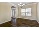 Simple and functional dining room featuring hardwood floors, a classic chandelier, and a large window at 6793 Oconee Pl, Fairburn, GA 30213