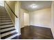 Home entryway features hardwood floors, staircase, and open doorway to living space at 6793 Oconee Pl, Fairburn, GA 30213