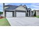 Spacious two-story home with large driveway and multi-car garage, complemented by lush green lawn at 6793 Oconee Pl, Fairburn, GA 30213