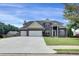 View of the attractive facade and large driveway of this handsome two story home at 6793 Oconee Pl, Fairburn, GA 30213