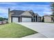 View of the attractive facade and large driveway of this handsome two story home at 6793 Oconee Pl, Fairburn, GA 30213