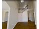 Bright foyer featuring hardwood floors, staircase with white railings, and views into other rooms at 6793 Oconee Pl, Fairburn, GA 30213