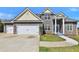 Charming two-story home featuring a stone facade, well-manicured lawn, and an attached three-car garage at 6793 Oconee Pl, Fairburn, GA 30213