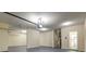 Bright three-car garage with a door leading to the house, offering convenient access to the kitchen at 6793 Oconee Pl, Fairburn, GA 30213