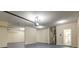 Two-car garage with high ceilings and sealed concrete floors, also showing entrance to the home at 6793 Oconee Pl, Fairburn, GA 30213