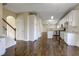Hallway view showcases the hardwood flooring, staircase, and kitchen at 6793 Oconee Pl, Fairburn, GA 30213