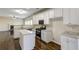 Bright kitchen features white cabinets, an island, and stainless steel appliances at 6793 Oconee Pl, Fairburn, GA 30213