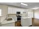 Beautiful kitchen with white cabinets, granite countertops, and stainless steel appliances for a sleek look at 6793 Oconee Pl, Fairburn, GA 30213