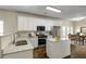 Bright kitchen featuring white cabinetry, granite countertops, a center island, and stainless steel appliances at 6793 Oconee Pl, Fairburn, GA 30213