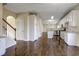Spacious kitchen and staircase featuring stainless appliances, granite counters, and hardwood floors at 6793 Oconee Pl, Fairburn, GA 30213