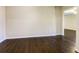 Inviting living room features dark hardwood floors, and a neutral color palette to create a bright, airy ambiance at 6793 Oconee Pl, Fairburn, GA 30213
