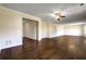 Bright living room featuring hardwood floors, neutral paint, and a view to the hallway at 6793 Oconee Pl, Fairburn, GA 30213