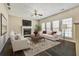 A well-staged living room with neutral sofas, a fireplace, and an area rug at 6793 Oconee Pl, Fairburn, GA 30213