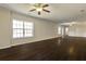 Open living room featuring hardwood floors, neutral-colored walls and natural lighting at 6793 Oconee Pl, Fairburn, GA 30213