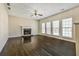 Spacious living room featuring a fireplace, hardwood floors, neutral walls, and a ceiling fan at 6793 Oconee Pl, Fairburn, GA 30213