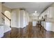 Spacious living area features staircase, hardwood floors, and adjacent kitchen with modern appliances at 6793 Oconee Pl, Fairburn, GA 30213