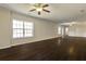 Spacious living room with hardwood flooring and a neutral color palette to create a warm, airy ambiance at 6793 Oconee Pl, Fairburn, GA 30213