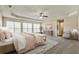 Large main bedroom with a tray ceiling, a ceiling fan, and lots of natural light at 6793 Oconee Pl, Fairburn, GA 30213