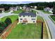Two-story home's rear view shows large yard with wood fence, wooden deck, and window-filled rear at 6793 Oconee Pl, Fairburn, GA 30213