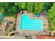 Top-down shot of the community pool and playground, surrounded by lush greenery and lounge chairs at 8070 Georgetown Cir, Suwanee, GA 30024