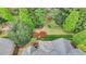 Aerial view of home with the back yard, terraced steps, lush landscaping and patio area at 8070 Georgetown Cir, Suwanee, GA 30024