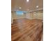 Expansive basement area with hardwood floors and recessed lighting, great for customization at 8070 Georgetown Cir, Suwanee, GA 30024