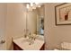 Bathroom featuring a vanity with a white countertop, and a large mirror reflecting the bedroom at 8070 Georgetown Cir, Suwanee, GA 30024