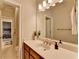 Bright bathroom vanity with modern fixtures and a large mirror, offering a clean design at 8070 Georgetown Cir, Suwanee, GA 30024