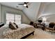 Bedroom with sloped ceiling, large window, comfortable bed, and home office area at 8070 Georgetown Cir, Suwanee, GA 30024