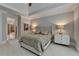 Inviting bedroom featuring a plush bed, soft lighting, and access to an en-suite bathroom at 8070 Georgetown Cir, Suwanee, GA 30024